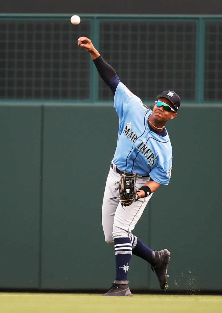 The Mariners’ Julio Rodriguez throws the ball in from the outfield during a spring game against the Dodgers on March 9, 2019, in Phoenix. (AP Photo/Sue Ogrocki)
