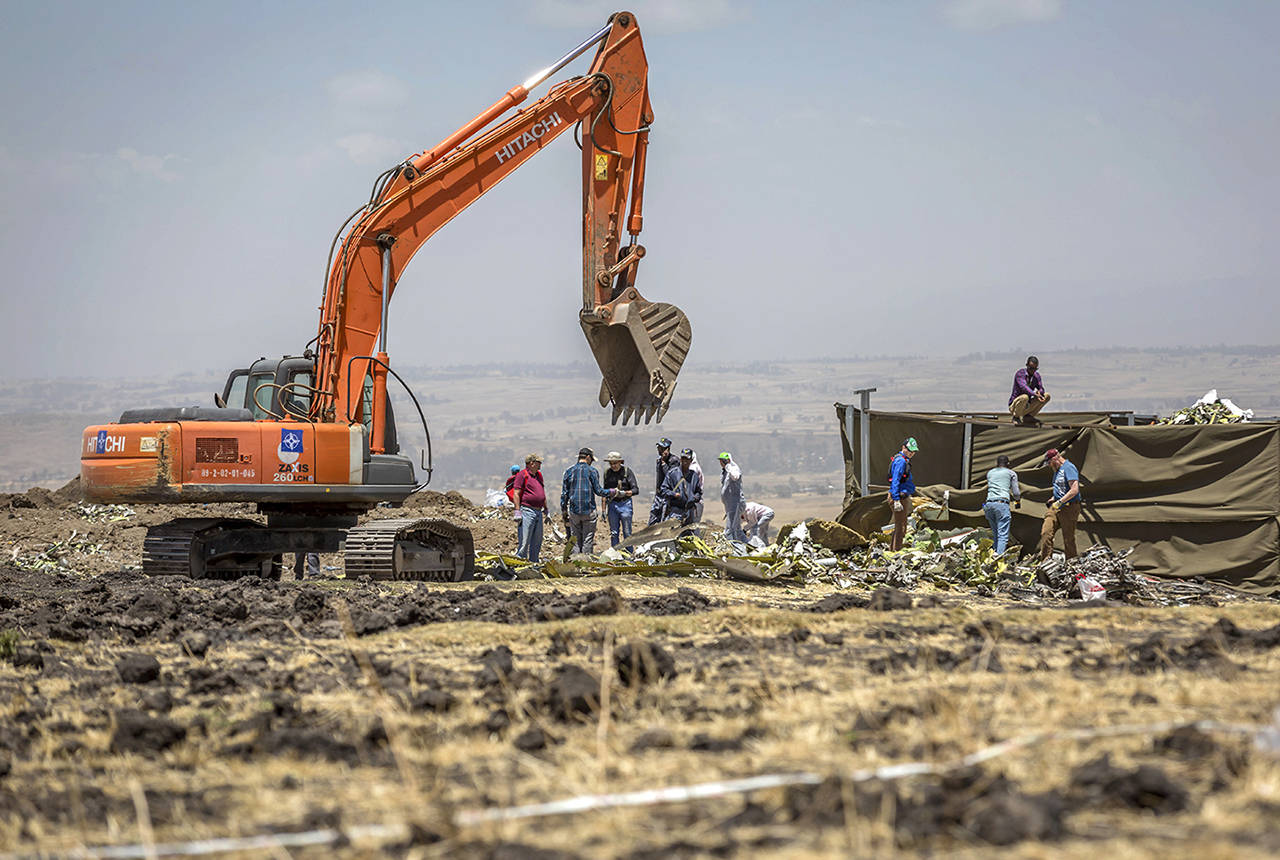 Investigators continue recovery work at the scene where the Ethiopian Airlines Boeing 737 Max 8 crashed shortly after takeoff on Sunday killing all 157 on board, near Bishoftu, south-east of Addis Ababa, in Ethiopia, on Friday. Analysis of the flight recorders has begun in France, the airline said Friday, while in Ethiopia officials started taking DNA samples from victims’ family members to assist in identifying remains. (AP Photo/Mulugeta Ayene)