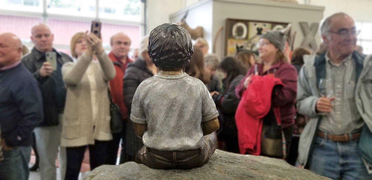 The unveiling of the statue drew quite the crowd to the Friedman Oens Gallery on Bainbridge Island. (Nick Twietmeyer / Kitsap News Group)