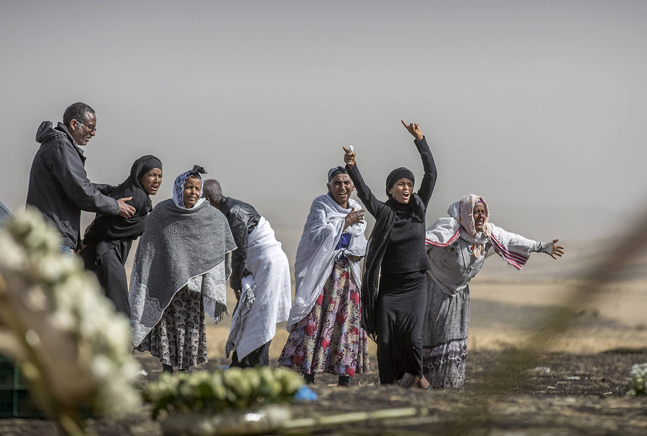 Ethiopian relatives of crash victims grieve at the site where the Ethiopian Airlines Boeing 737 Max 8 crashed shortly after takeoff on Sunday killing all 157 on board, near Bishoftu, south-east of Addis Ababa, in Ethiopia, on Thursday. (AP Photo/Mulugeta Ayene)