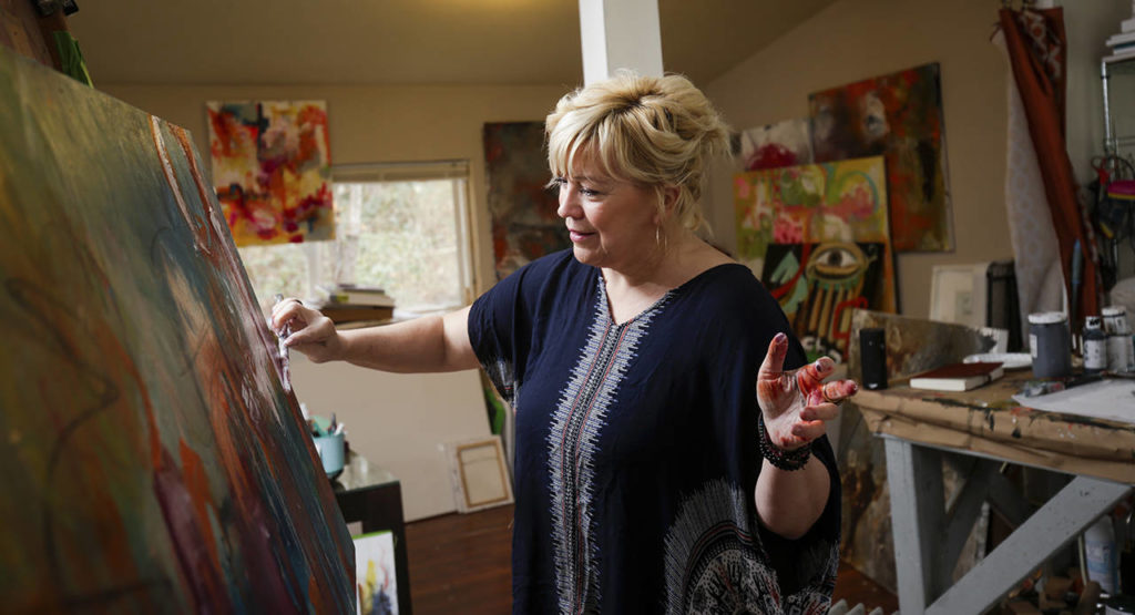 Cort doesn’t like to limit herself by painting with just brushes. (Andy Bronson / The Herald)
