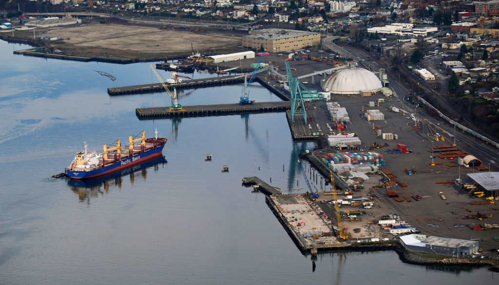 The bulk carrier Jamaica Bay is pushed into the Port of Everett by a pair of tugs near the former Kimberly-Clark mill site in January. (Andy Bronson / The Herald)
