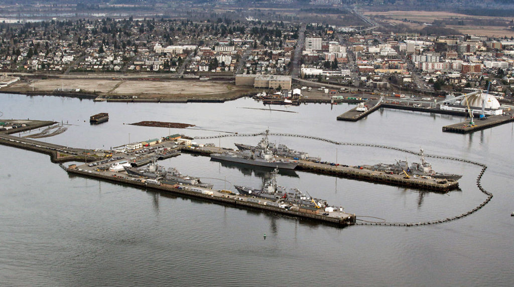 The former Kimberly-Clark mill site is seen from the water, beyond destroyers docked at Naval Station Everett, in January. (Andy Bronson / The Herald)
