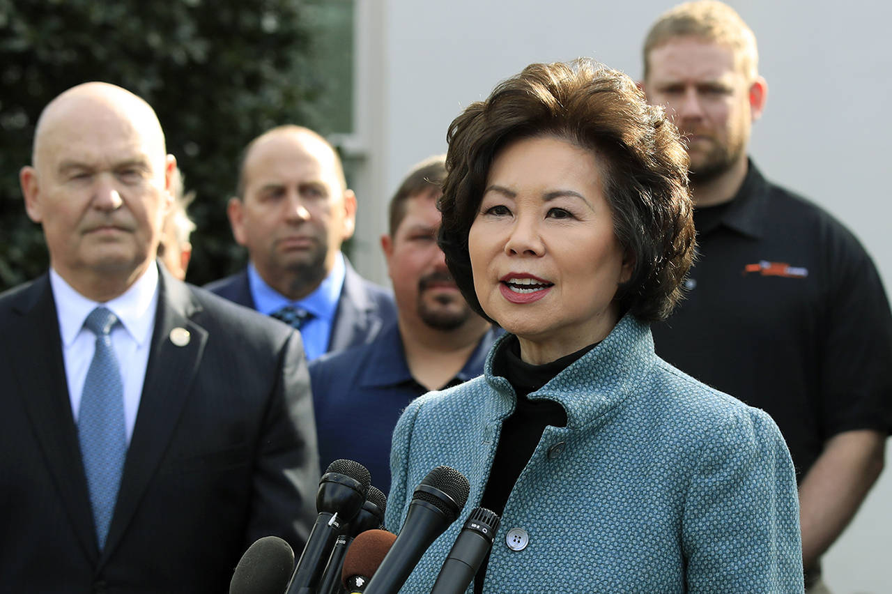 Transportation Secretary Elaine Chao (right) with U.S. Maritime Administration Administrator Mark Buzby (left) speaks to reporters outside the West Wing of the White House following President Donald Trump’s signing of the executive order supporting the transition of active duty service members and military veterans into the Merchant Marine, March 4 in Washington. (AP Photo/Manuel Balce Ceneta, file)