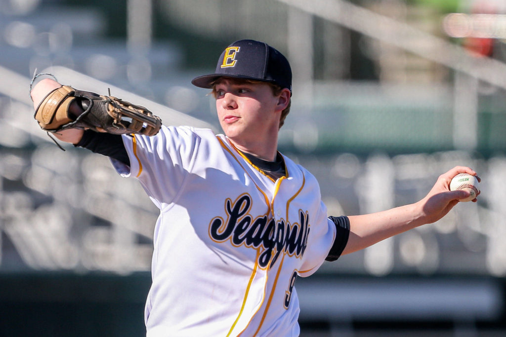 Everett’s Aaron Robertson throws a pitch against Arlington at during a March 19 game at Funko Field at Everett Memorial Stadium. (Kevin Clark / The Herald)
