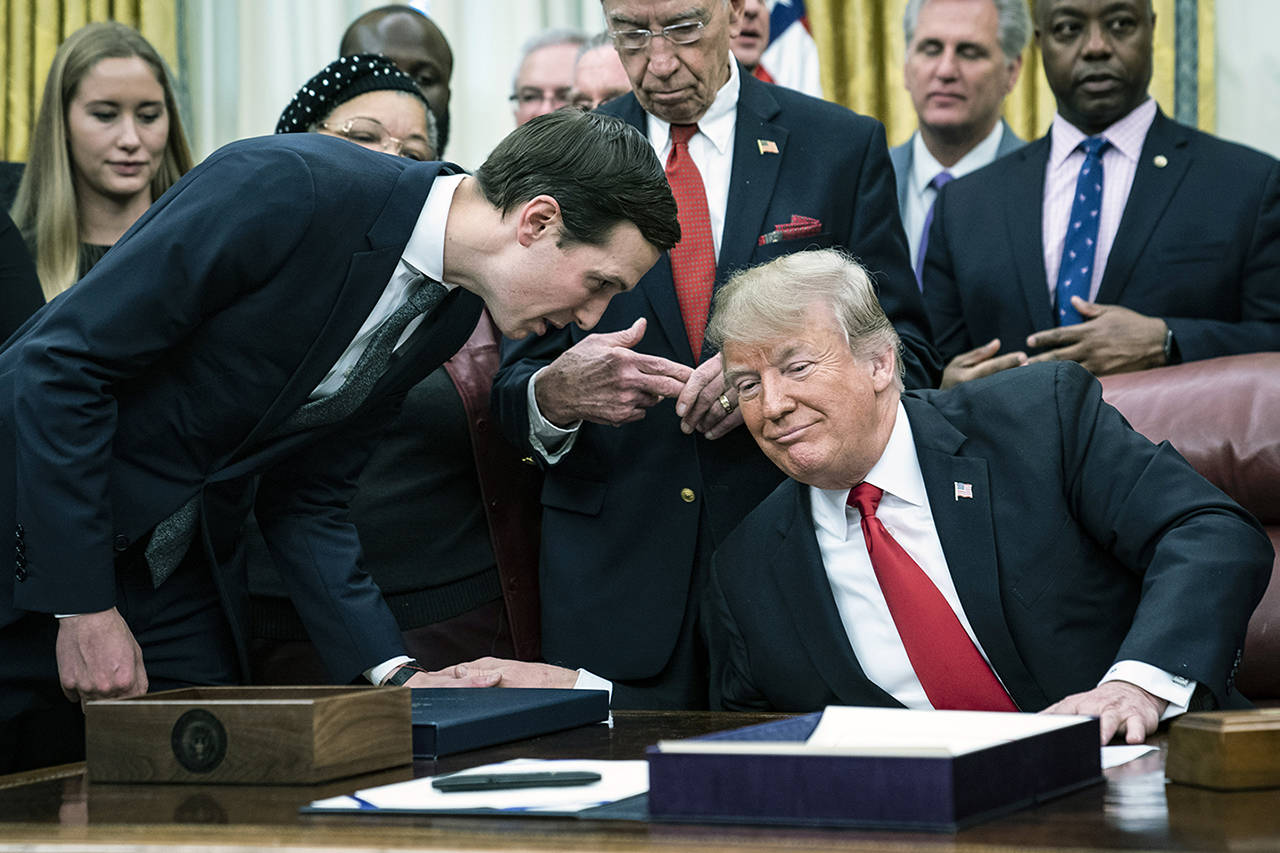 Jared Kushner speaks with President Trump during a signing ceremony for a criminal justice bill in the White House in December. (Jabin Botsford/Washington Post)