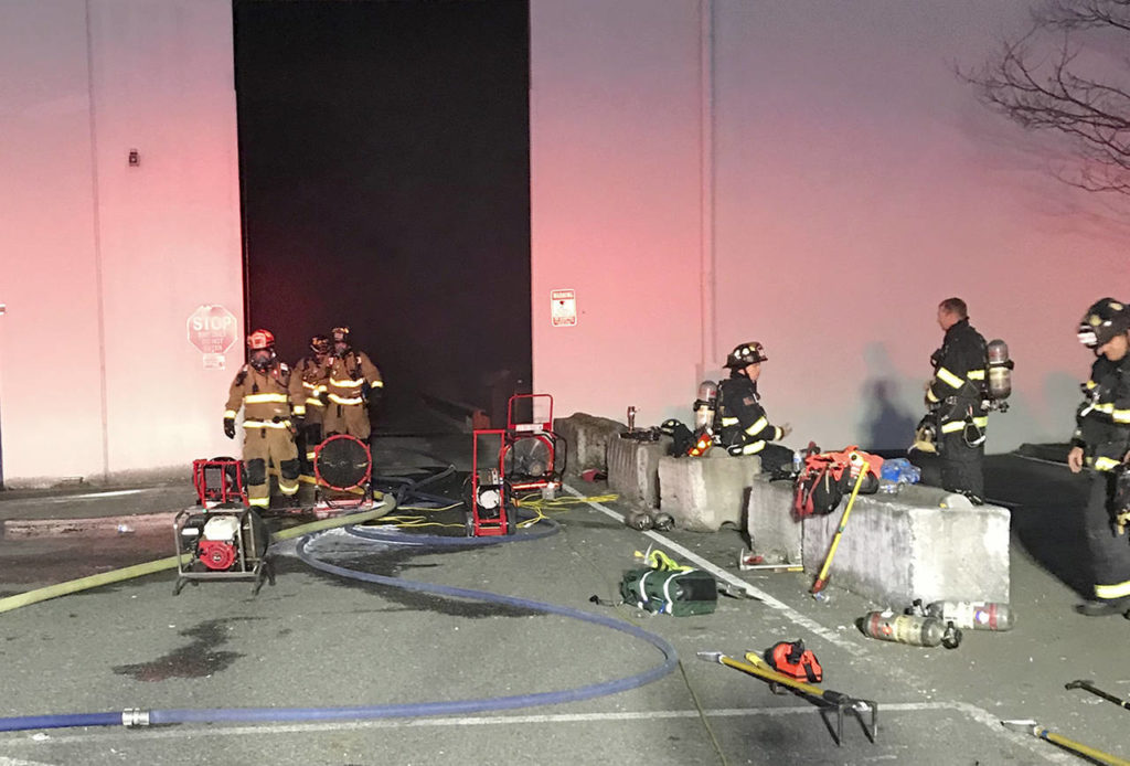 An employee discovered smoke and flames coming from a bale of newspaper and cardboard inside the Fibres International warehouse near Paine Field on Thursday night. (South County Fire)
