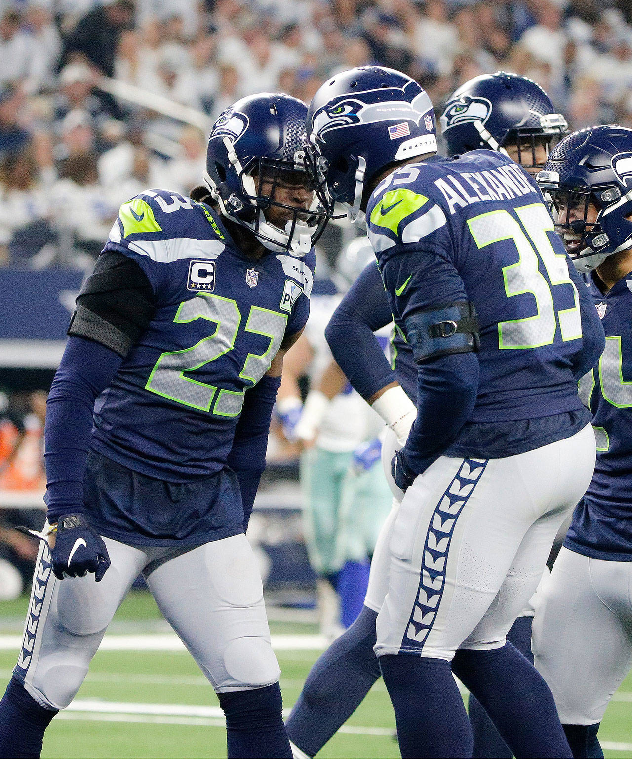 Seattle’s Maurice Alexander (right) celebrates with Neiko Thorpe after the Seahawks’ punt coverage unit downed a Dallas punt before in entered the end zone during a Jan. 5 game in Arlington, Texas. (AP Photo/Michael Ainsworth)