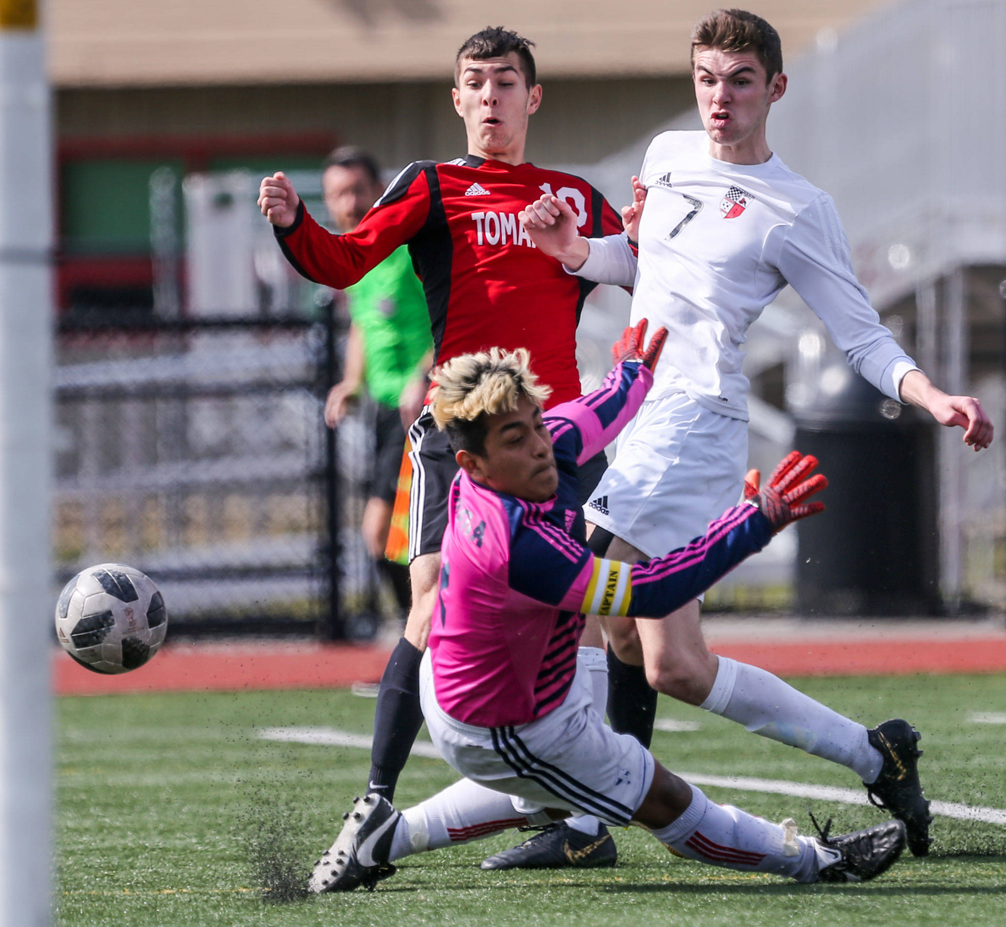 Marysville Pilchuck’s Kyle Matson (left) charges the net with Snohomish goalkeeper Michael Herrera (bottom) and Adam Kowalchyk defending during the teams’ Wesco 3A/2A showdown Saturday at Quil Ceda Stadium in Marysville. The match ended in a 1-1 draw. (Kevin Clark / The Herald)