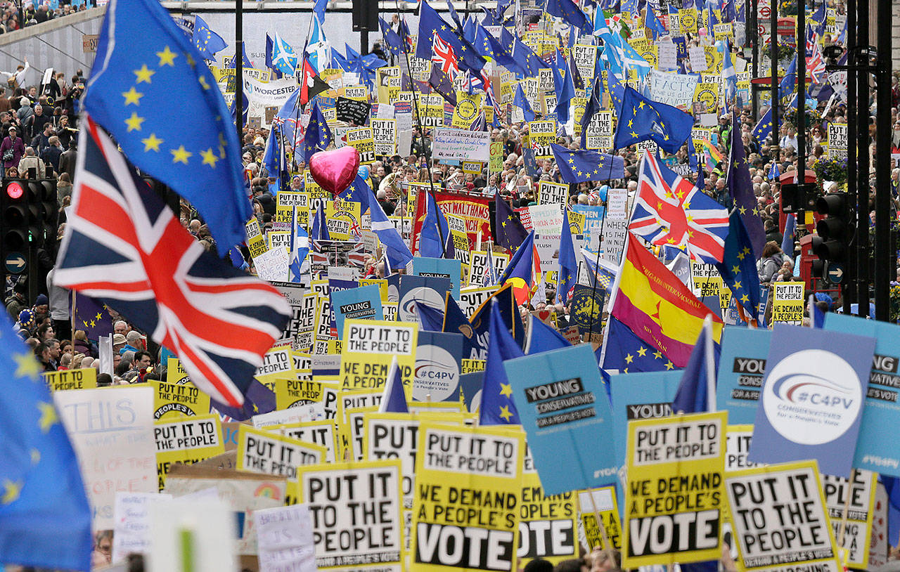 Demonstrators carry posters and flags during an anti-Brexit march in London on Saturday. The march, organized by the People’s Vote campaign is calling for a final vote on any proposed Brexit deal. This week the EU has granted Britain’s Prime Minister Theresa May a delay to the Brexit process. (AP Photo/Tim Ireland)
