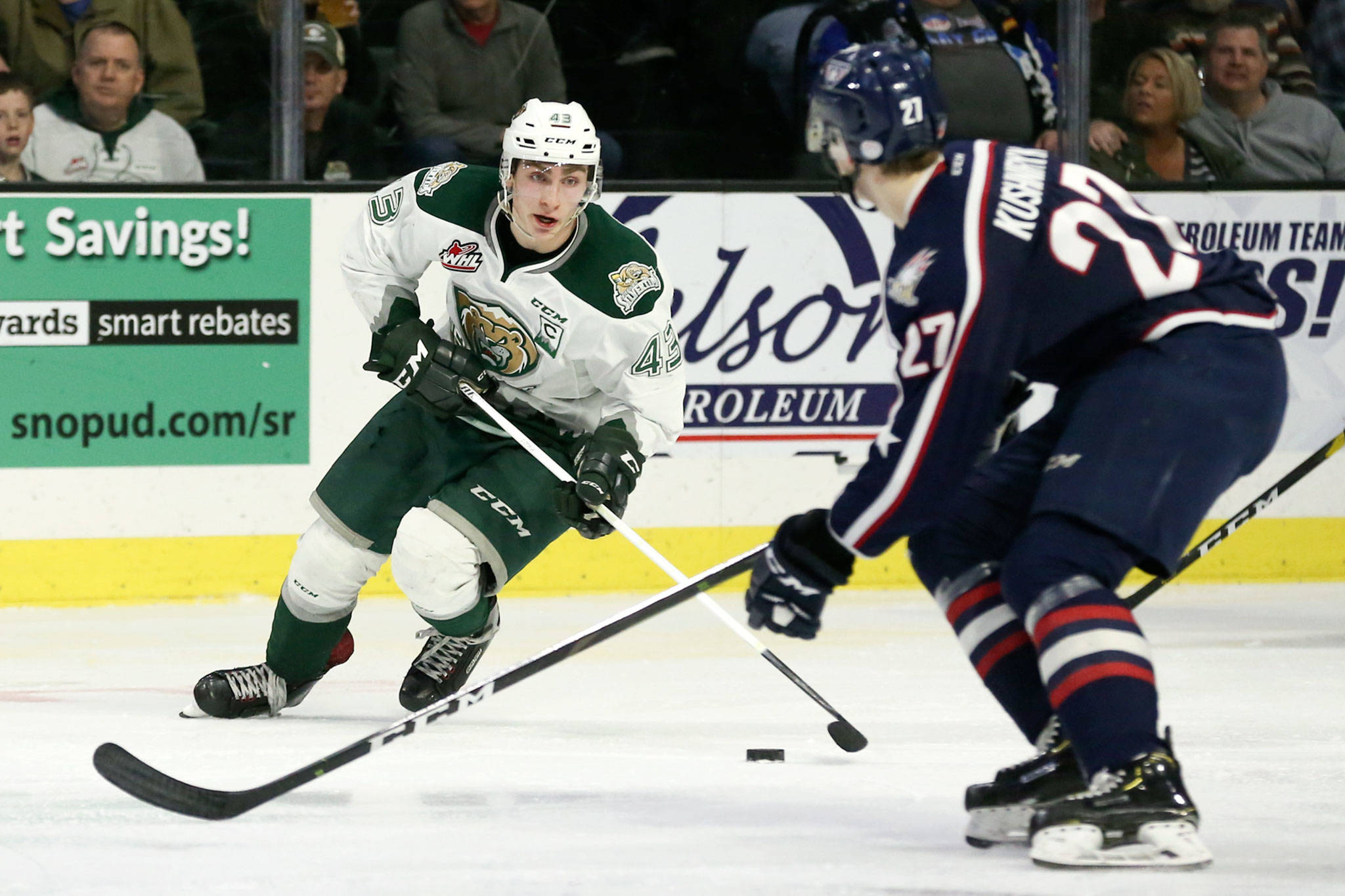 Everett’s Connor Dewar controls the puck with Tri-City’s Nolan Yaremko defending during the first game of the playoffs Friday night at Angel of the Winds Arena in Everett. (Kevin Clark / The Herald)