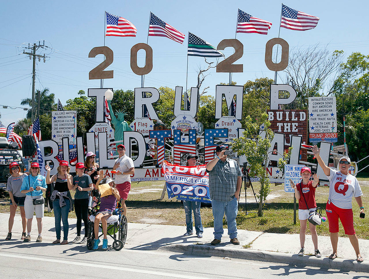 Supporters of President Donald Trump are seen from the media van in the motorcade accompanying the president in West Palm Beach, Fla., Saturday, March 23, en route to Mar-a-Lago in Palm Beach, Fla. (AP Photo/Carolyn Kaster)