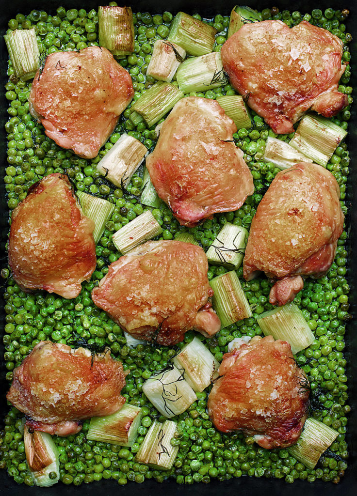 Another easy dinner, chicken and pea traybake is flavored with white vermouth. (Jonathan Lovekin)
