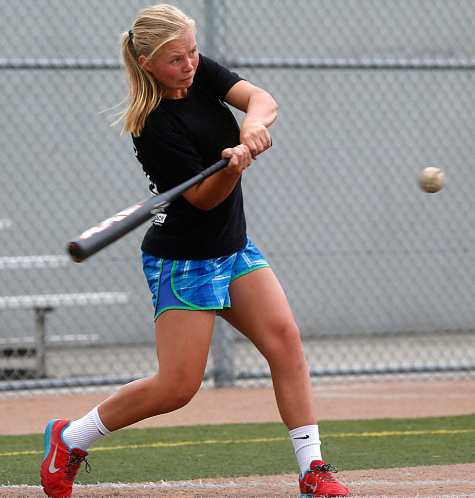 Megan Dedrick shows excellent power during batting practice, Aug. 11, 2014, at Lincoln Field in Everett. She took that swing to Loyola Marymount University’s softball team. (Dan Bates / The Herald)
