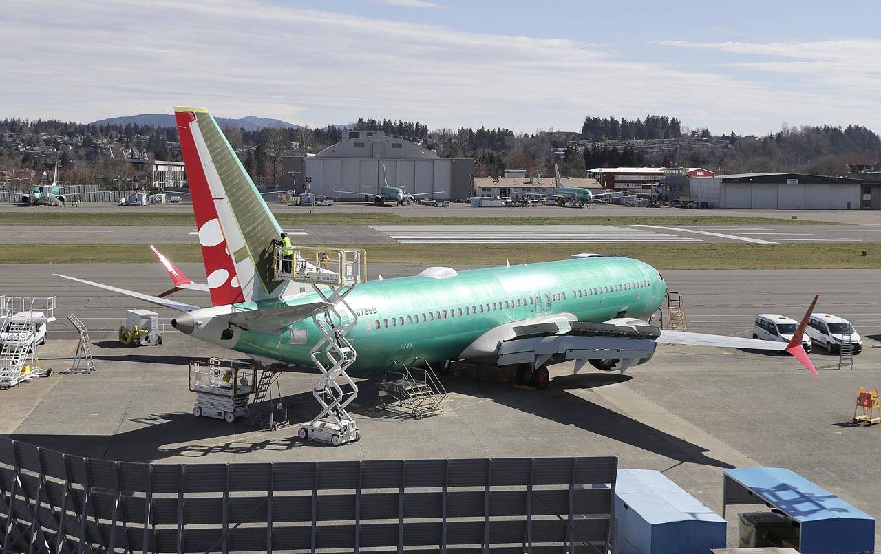 A worker on a lift works on a Boeing 737 Max 8 being built for SpiceJet at Renton Municipal Airport in Renton on March 22. (Ted S. Warren/ Associated Press file)