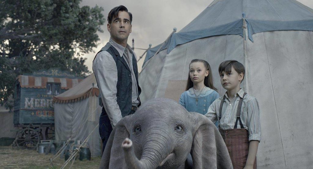 From left, Colin Farrell, Nico Parker and Finley Hobbins star as a family who takes care of the baby elephant in “Dumbo.” In this remake, none of the animals utter a word. (Walt Disney Pictures)
