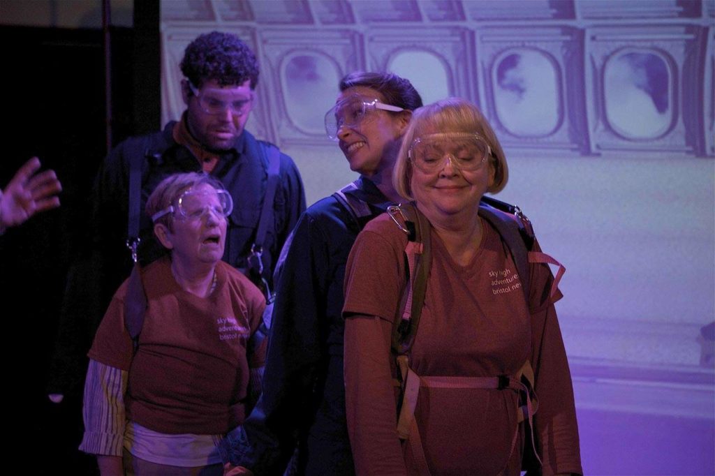 Melanie Calderwood (left) and Greg Klaciak (behind her) and Susan Connors (right) and Renee Gilbert (behind her) in a skydiving scene from the play. (Jim Sipes)
