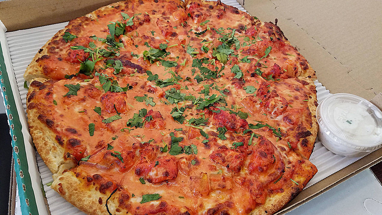 The butter chicken pizza is butter paneer marinated in Can Am’s curry sauce, jalapenos, onions, green peppers, tomatoes, mozzarella cheese and pizza sauce. (Sharon Salyer/The Herald)