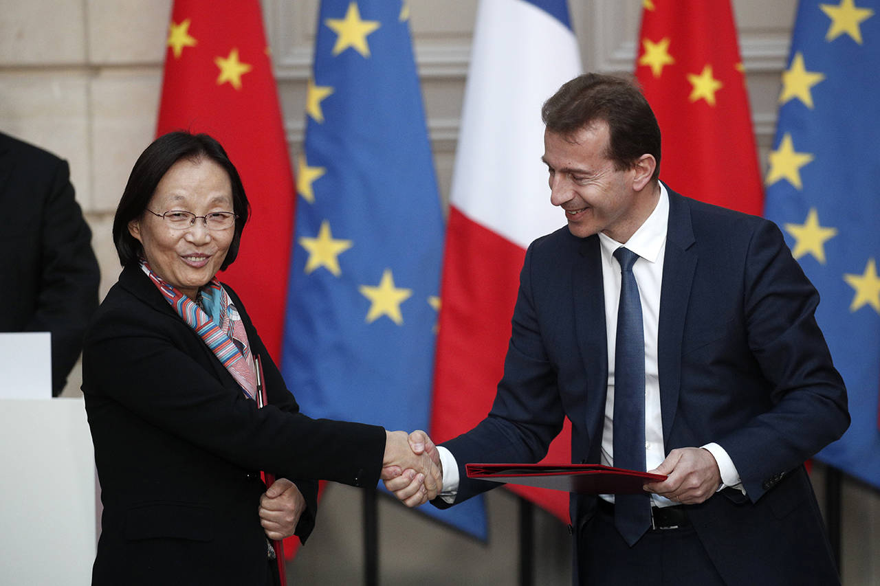 President of Airbus’s commercial aircraft business Guillaume Faury (right) and Wu Shuang, President of 21st Century, shake hands during an agreement signing ceremony at the Elysee Palace in Paris, France on Monday. (Yoan Valat/Pool Photo via AP)