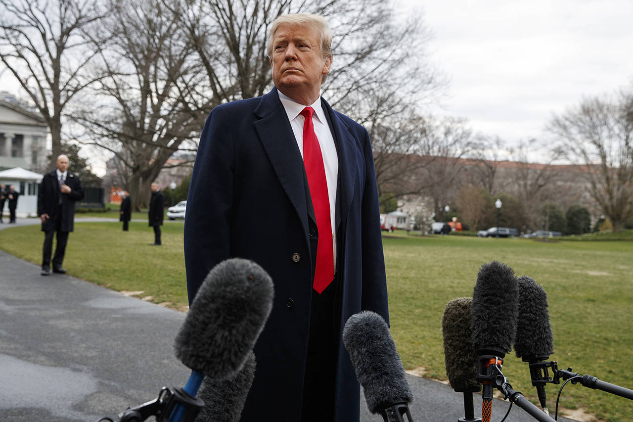 President Donald Trump listens to a question as he speaks with reporters before boarding Marine One on the South Lawn of the White House on Friday in Washington. (AP Photo/Evan Vucci)