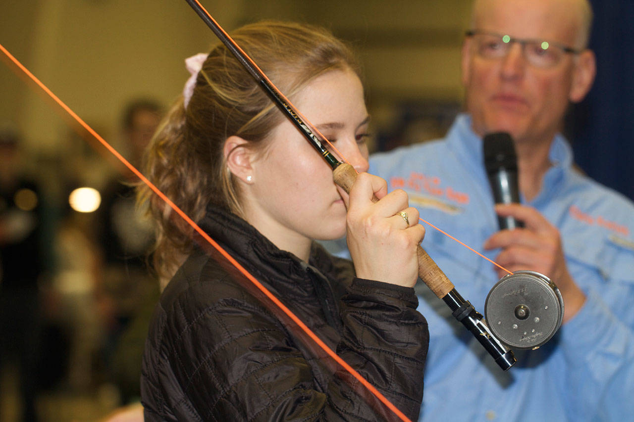 World fly casting champion Maxine McCormick, 15, provides casting tips at a recent fly fishing expo in Oregon. (Mike Benbow)