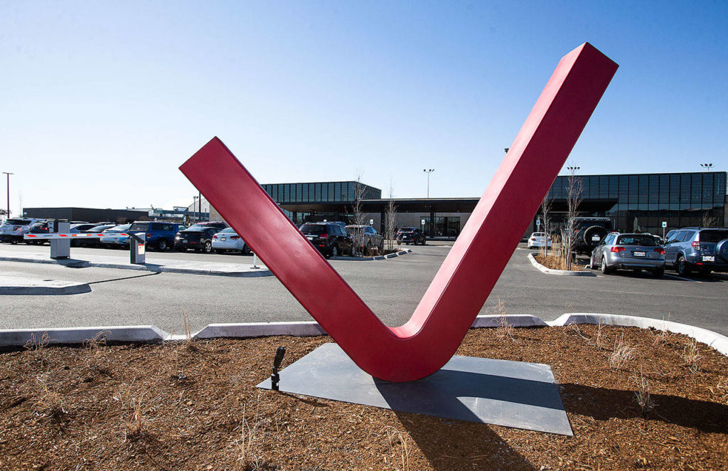 “Red Check” is visible at the parking lot entrance to the new terminal at Paine Field in Everett. (Andy Bronson / The Herald)
