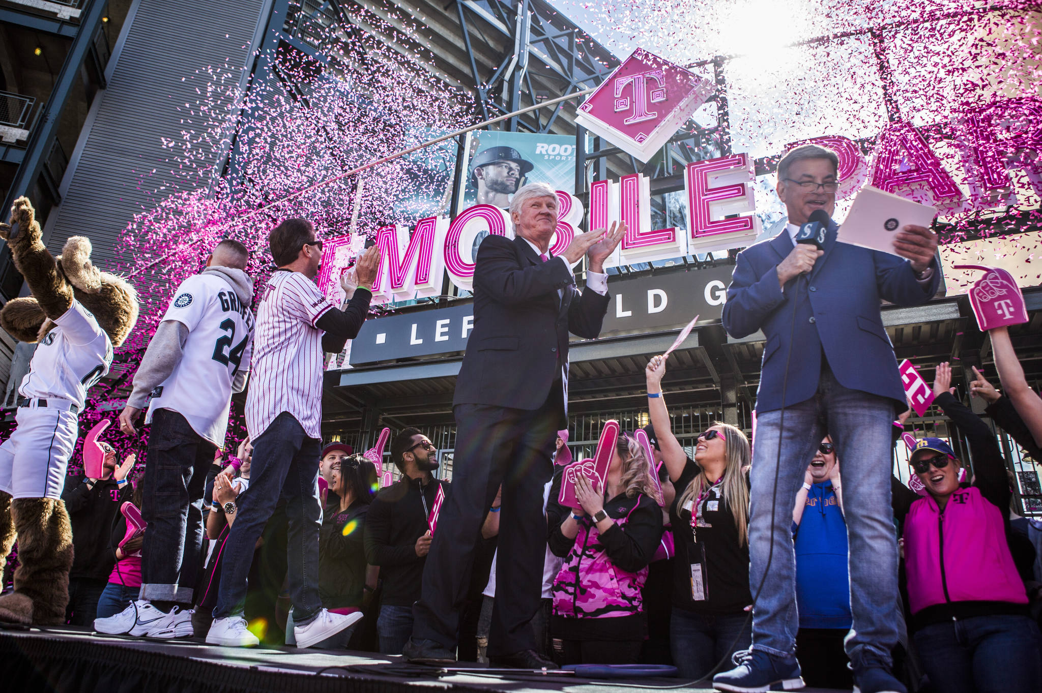 Mariners Chairman John Stanton, center, claps as the confetti canons go off during the T-Mobile Park Gate Opening Ceremony on Thursday, March 28, 2019 in Seattle, Wash. (Olivia Vanni / The Herald)