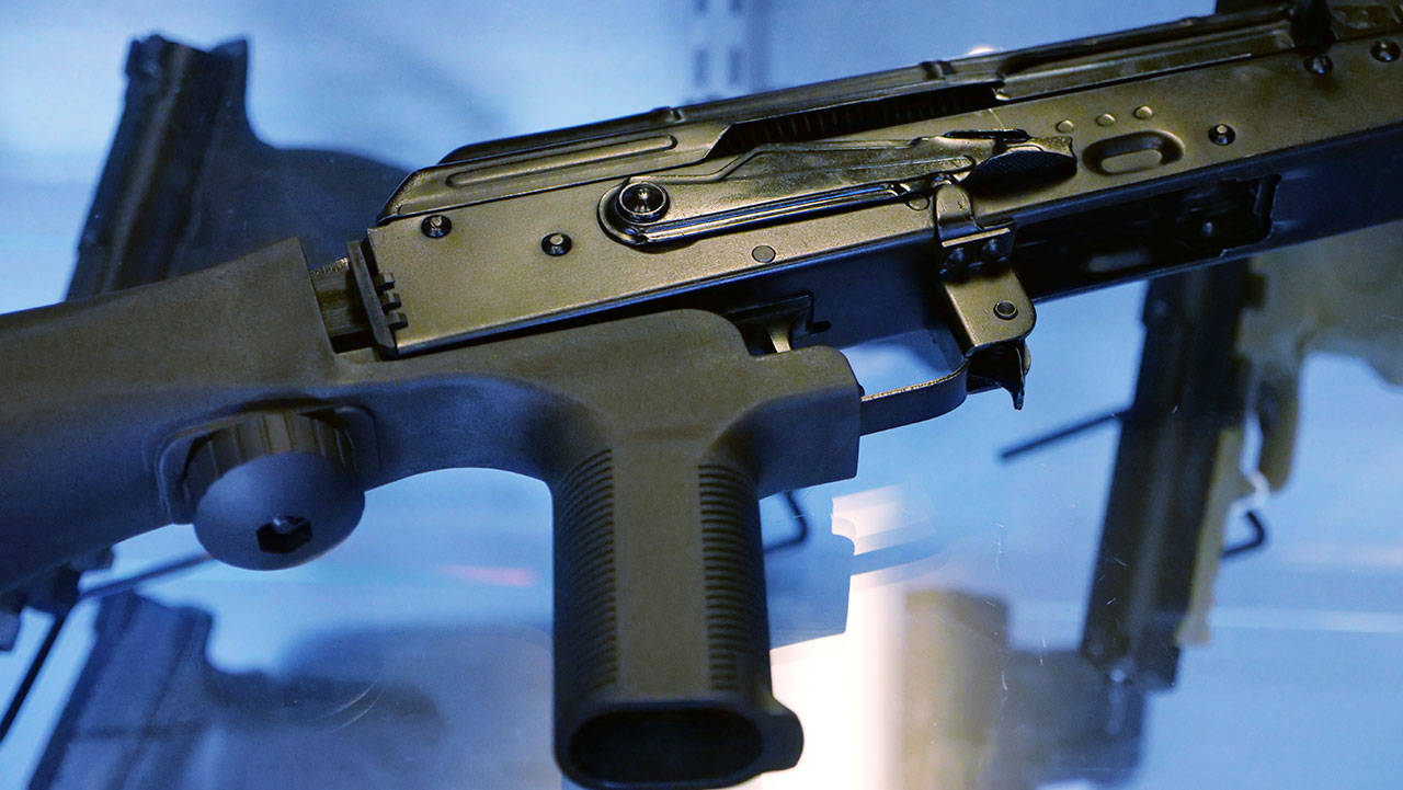 A “bump stock” is attached to a semi-automatic rifle at the Gun Vault store and shooting range in South Jordan, Utah, in 2017. (AP Photo/Rick Bowmer, File)