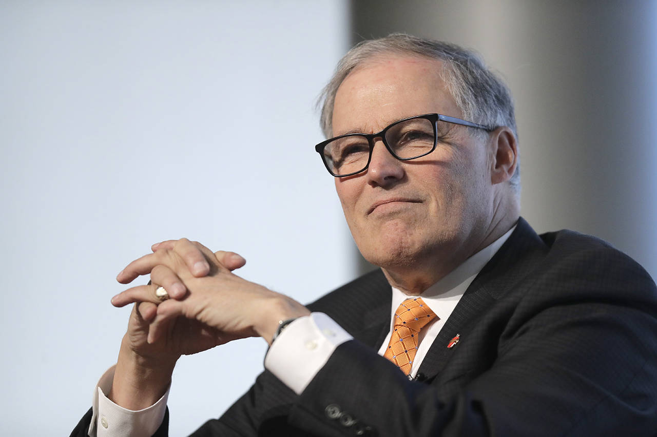 In this March 6 photo, Washington Gov. Jay Inslee listens as he takes part in a non-partisan panel discussion hosted by the University of Washington Jackson School and the American Security Project on the UW campus in Seattle. (AP Photo/Ted S. Warren, file)