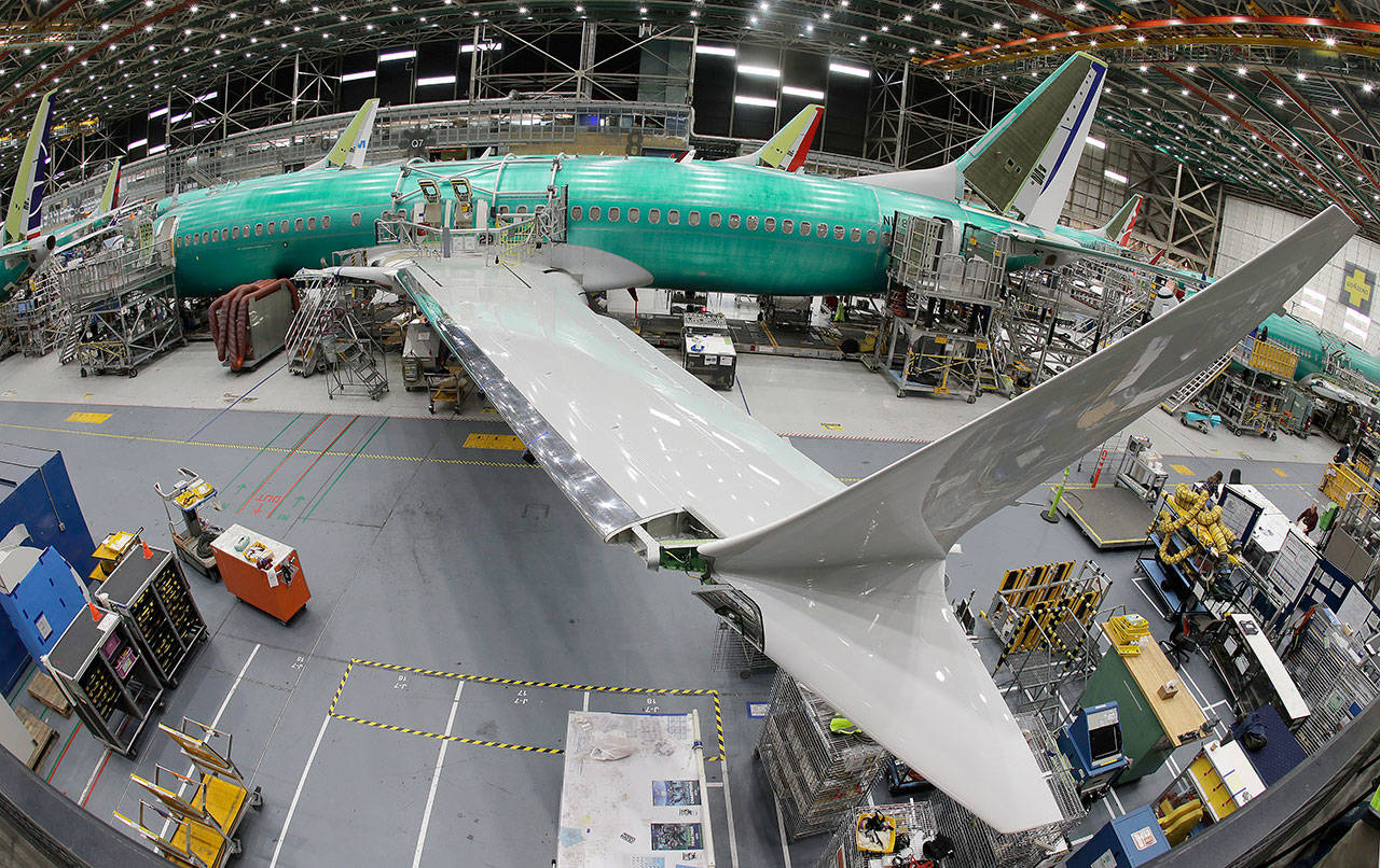 In this photo taken with a fish-eye lens, a Boeing 737 MAX 8 airplane sits on the assembly line during a brief media tour in Boeing’s 737 assembly facility Wednesday in Renton. (Ted S. Warren / Associated Press)