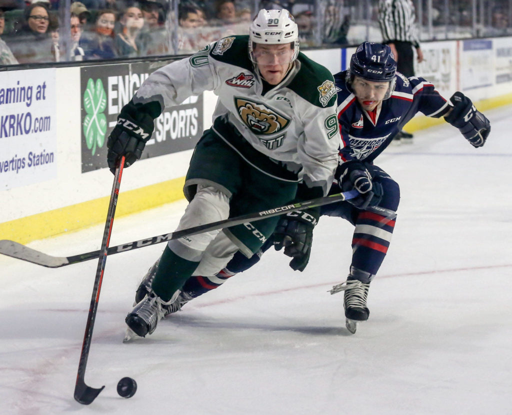 Everett’s Robbie Holmes controls the puck with Tri-City’s Samuel Stewart trailing in the second period during game 5 of the playoffs Saturday night at Angel of the Winds Arena in Everett on March 30, 2019. (Kevin Clark / The Herald)
