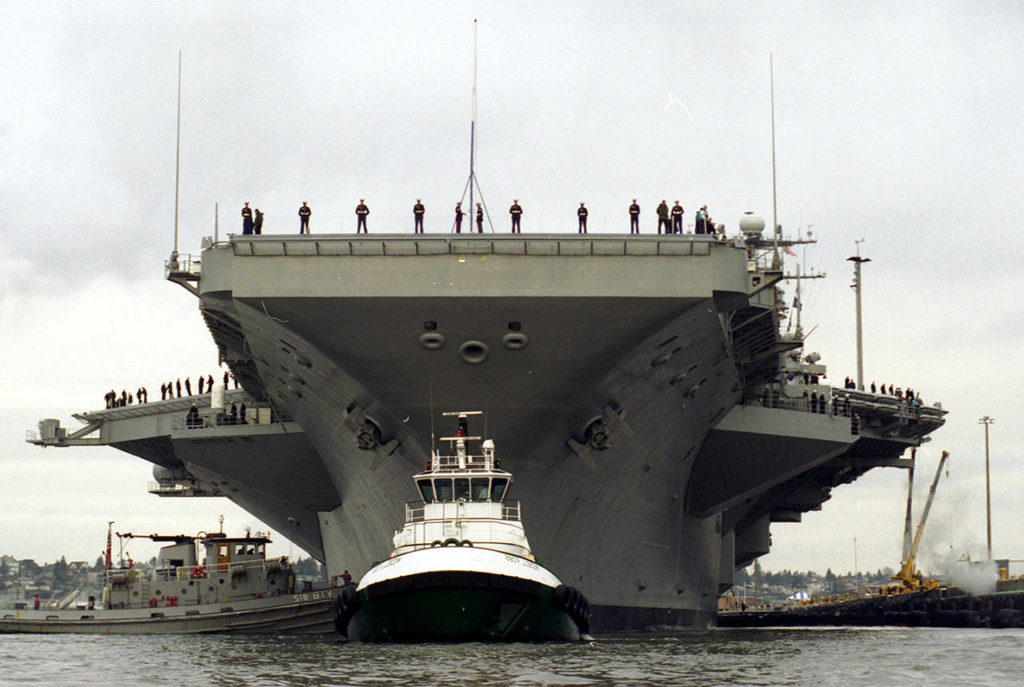 Guided by a tugboat, the USS Lincoln docks at Naval Station Everett for the first time on Jan. 8, 1997. (Dan Bates / Herald file)
