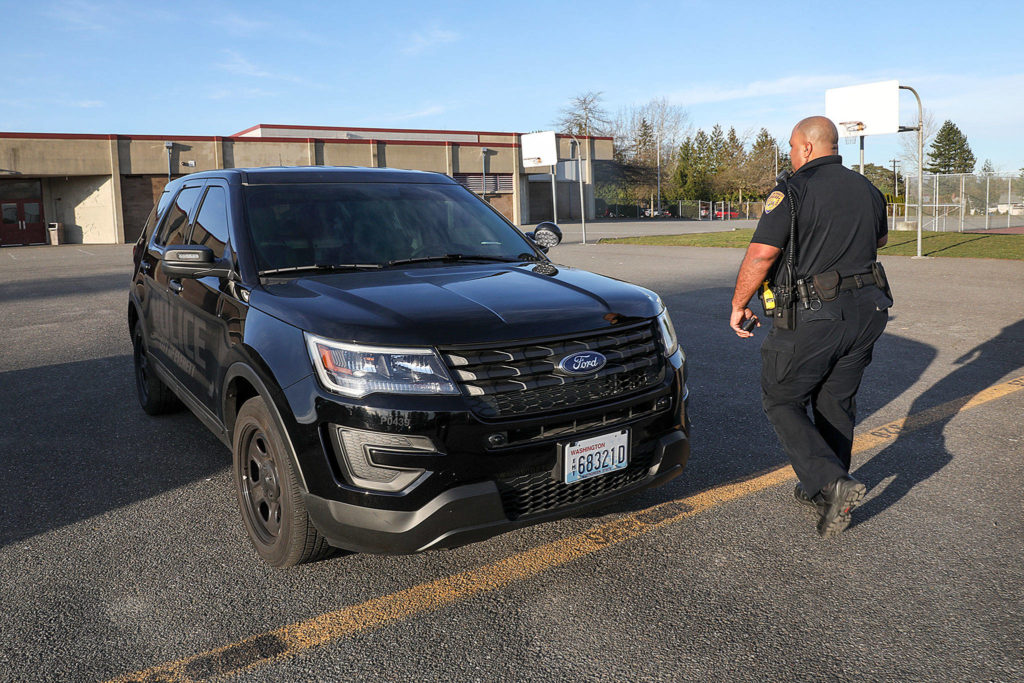 Officer Anthony Fletcher’s squad car is filled with typical police equipment: radio, computer, first-aid kit. But he also has a few basketballs he plans to pass out for the two new gang intervention programs. (Lizz Giordano / The Herald)
