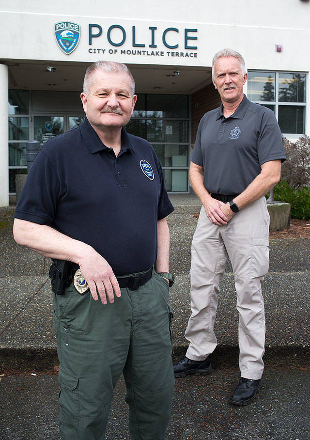 Pete Caw (left) is the new police chief in Mountlake Terrace. He and Cmdr. Doug Hansen (right) have worked a combined 70 years for the department. Hansen retires this week. (Andy Bronson / The Herald)