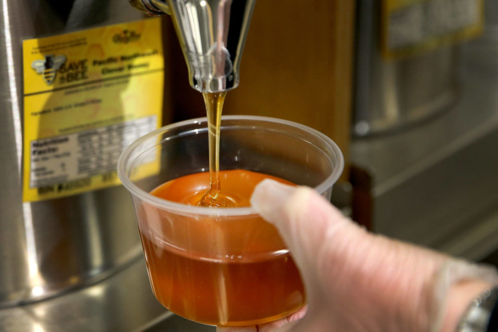 Find warm raw honey in the bulk foods section at Central Market. (Kevin Clark / The Herald)
