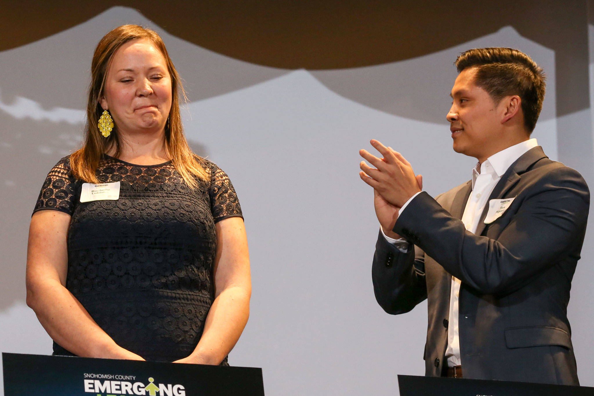 Fellow finalist Ton Nguyen (right) applauds Rochelle Lubbers for winning the 2019 Emerging Leader award Thursday night at the Marysville Opera House. (Kevin Clark / The Herald)