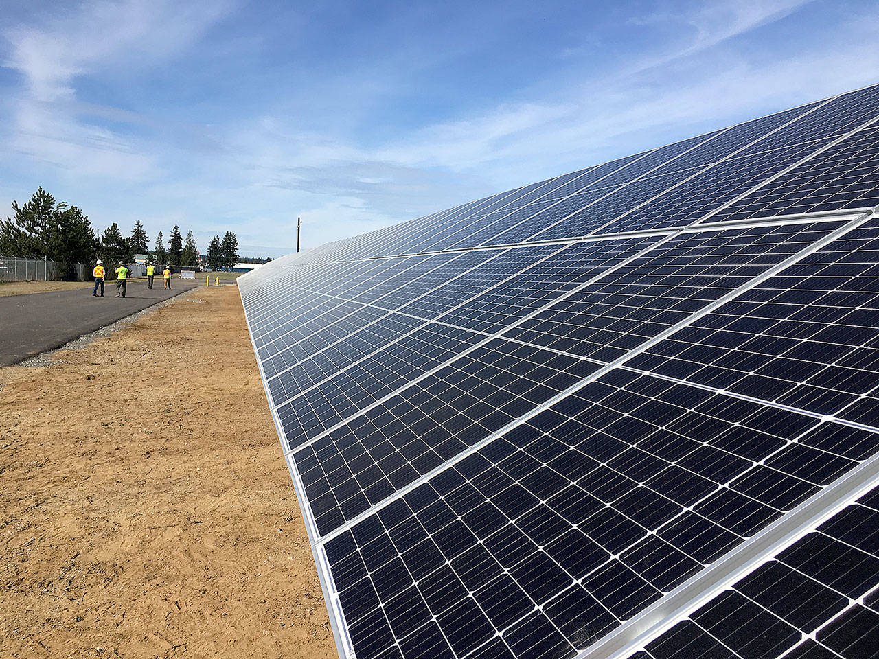 Rows of solar panels reflect sunlight at the Snohomish County PUD’s future Community Solar site near the Arlington Airport. PUD customers will be able to purchase units of the solar array starting April 22. (Snohomish County PUD)