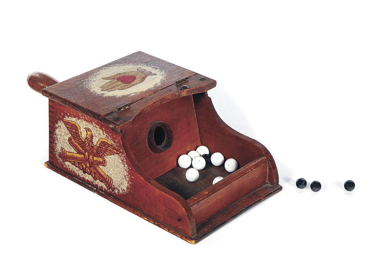 A blackball box and marbles used in Ohio in the early 1900s was auctioned at Garth’s for $500. The box had machine-made dovetailing and was decorated with decoupage prints in painted frames. (Cowles Syndicate Inc.)
