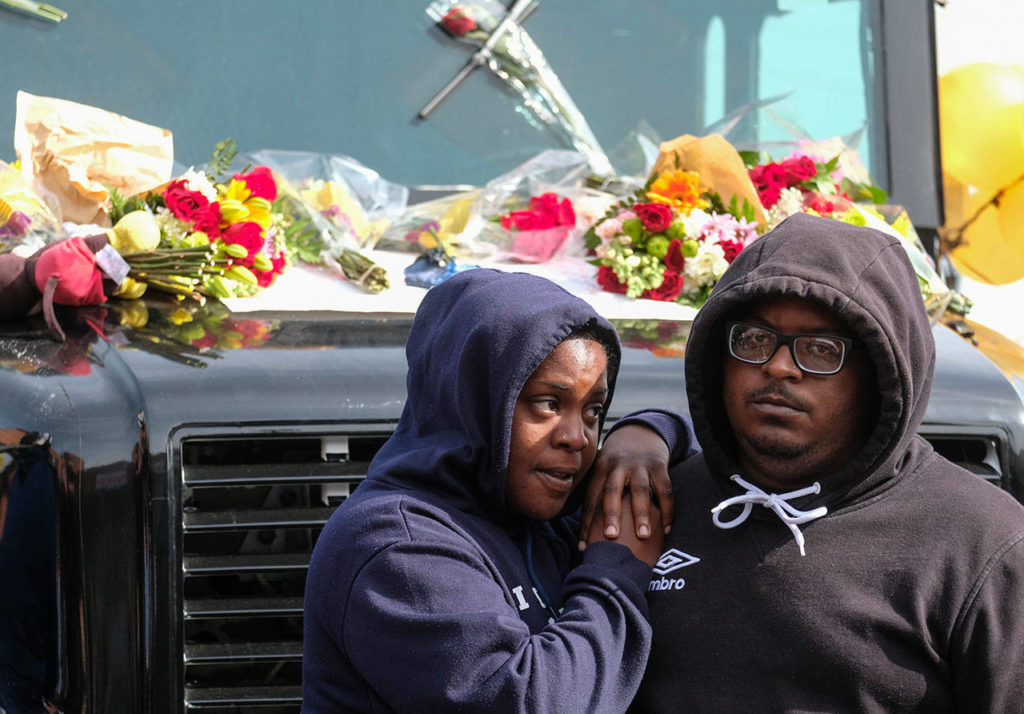 Fans of rapper Nipsey Hussle mourn his death Monday at a makeshift memorial on the parking lot of the Marathon Clothing store in Los Angeles. Hussle was killed Sunday in a shooting outside the clothing store he founded in South Los Angeles. (AP Photo/Ringo H.W. Chiu)
