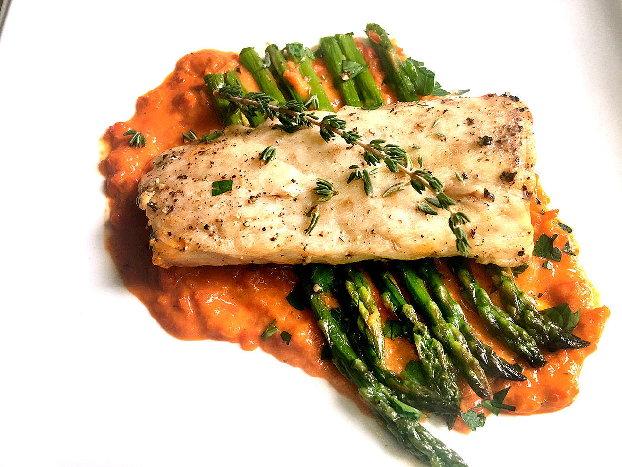 Broil mahi mahi and pair it with asparagus and red pepper sauce for a light yet filling meal. (Susan Selasky/Detroit Free Press)