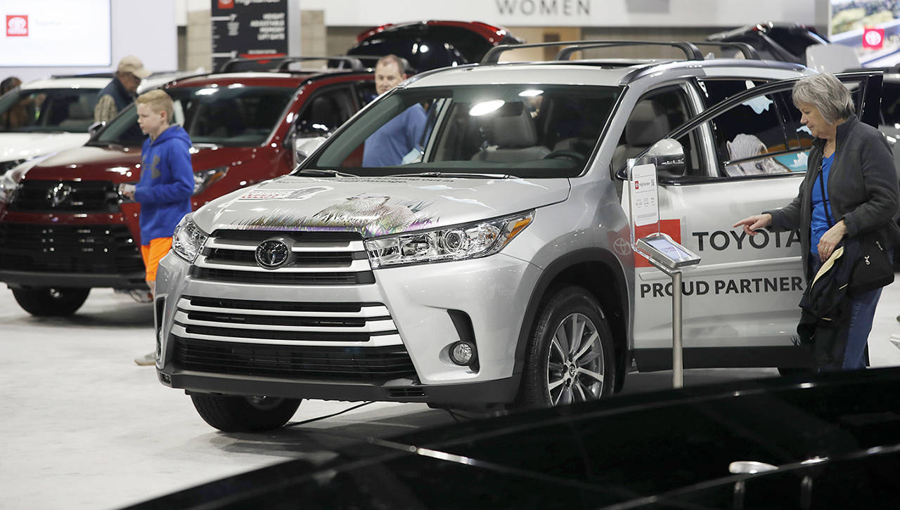 Buyers look over a row of 2019 Highlander sports-utility vehicles at the Toyota display at the auto show Thursday in Denver. (AP Photo/David Zalubowski)