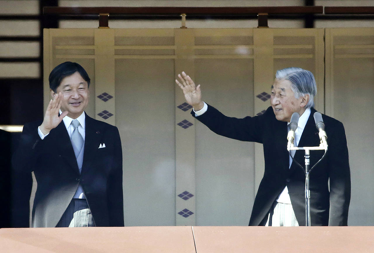 In this January 2018 photo, Japan’s Emperor Akihito (right), with Crown Prince Naruhito, waves to well-wishers from the bullet-proofed balcony during his New Year’s public appearance with his family members at Imperial Palace in Tokyo. (AP Photo/Eugene Hoshiko, File)