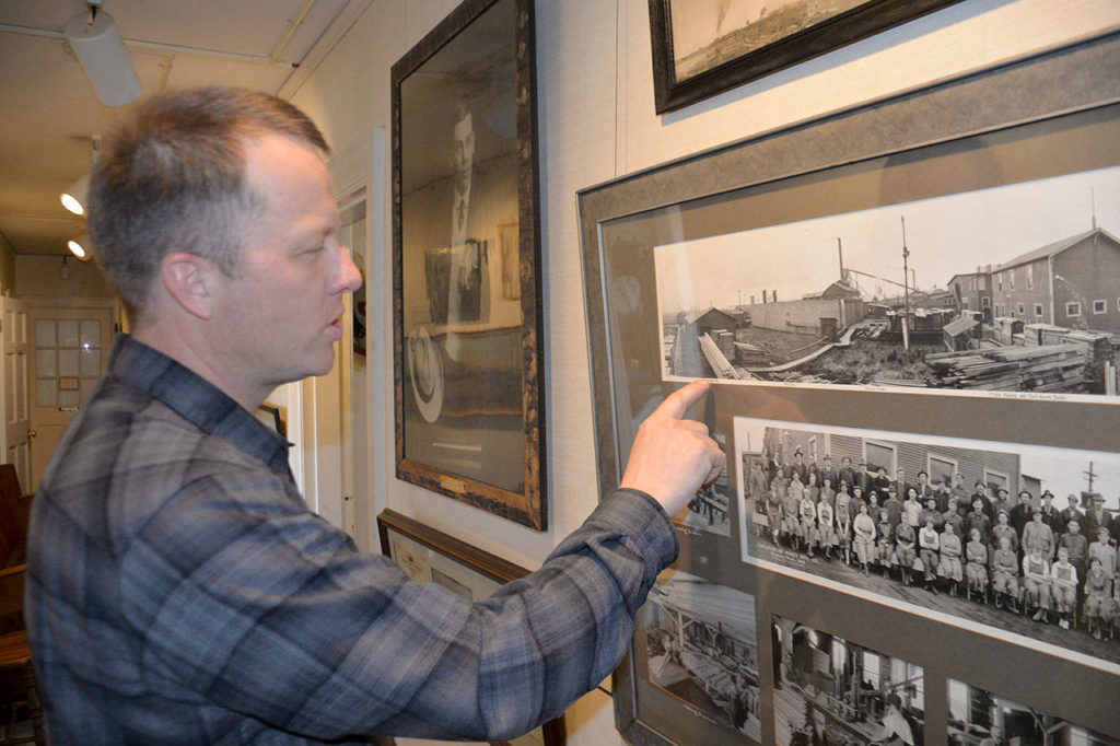 Polson Museum Director John Larson explains the process of creating guitar soundboards while showing photos from the Posey Manufacturing Company. (Louis Krauss / Grays Harbor News Group)
