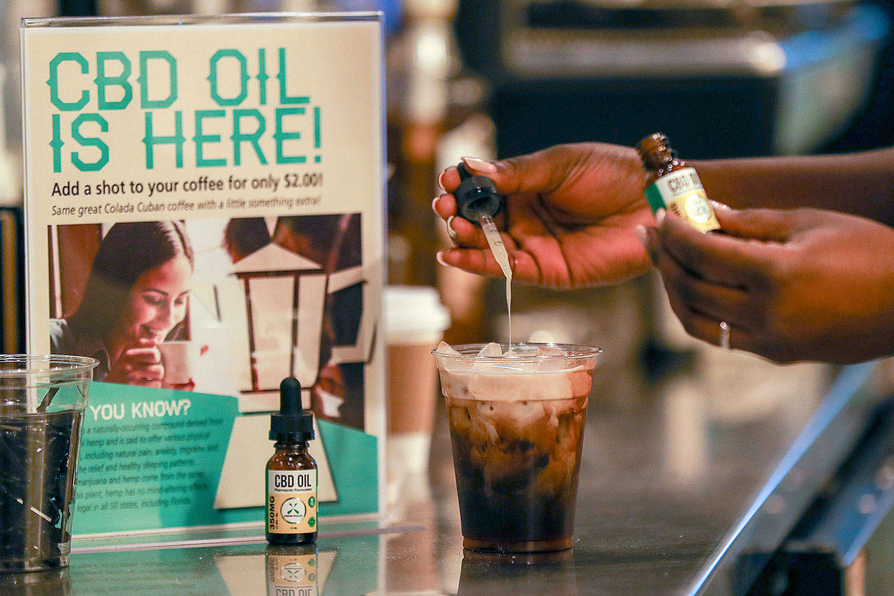 A worker adds CBD oil to a drink at a coffee shop in Fort Lauderdale, Florida, on Jan. 4, 2018. Cannabidiol is one of more than 100 compounds found in marijuana. (Jennifer Lett / South Florida Sun-Sentinel via AP)