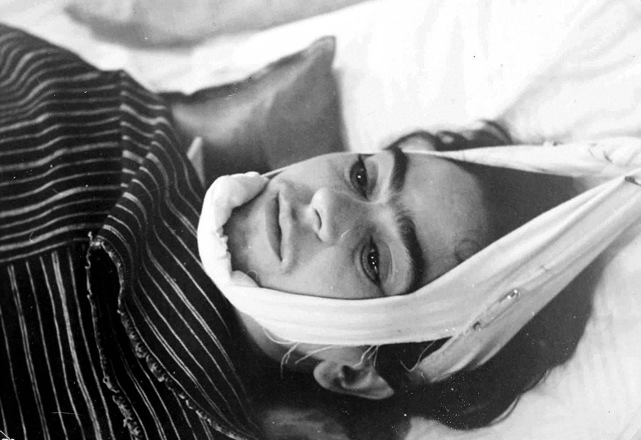 This 1940 photo provided by Sotheby’s shows artist Frida Kahlo with her head suspended by straps. The image is part of a collection of photographs by Nicholas Muray up for auction on Friday. (Nickolas Muray via Sothebys via AP)
