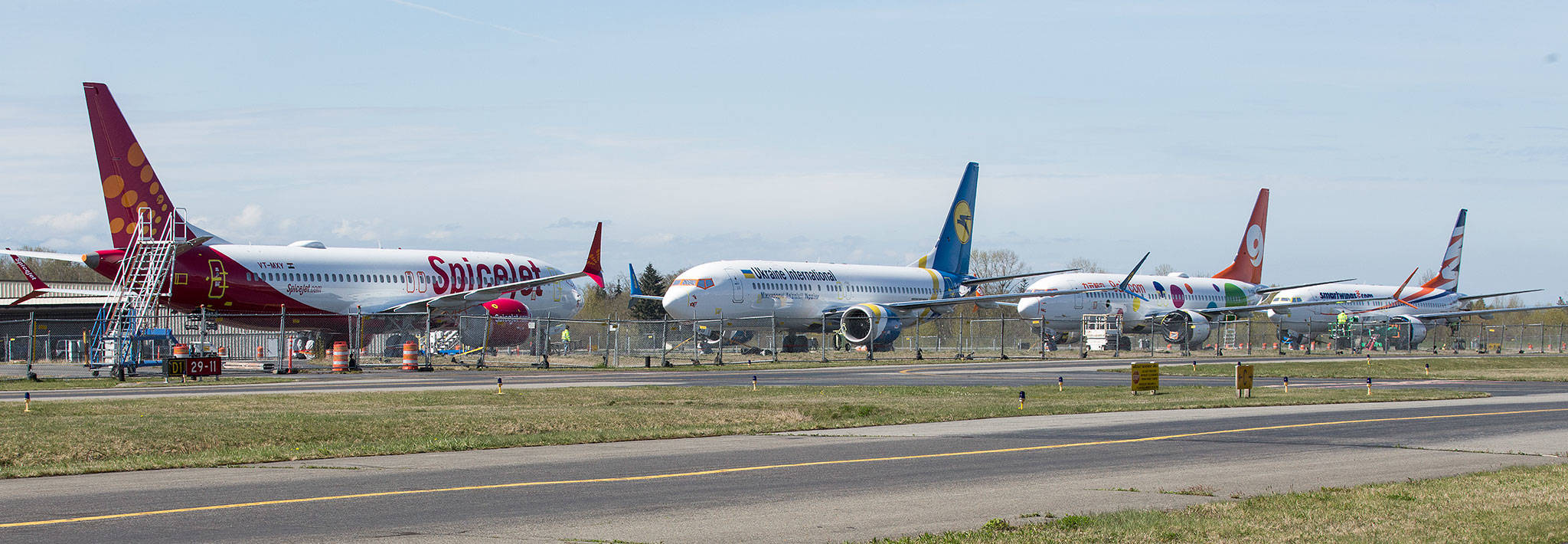 Boeing 737 MAX planes are parked on the closed crosswind runway at Paine Field on Thursday in Everett. (Andy Bronson / The Herald)