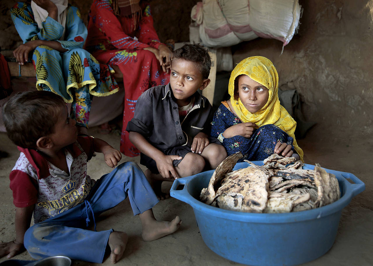 In this 2018 photo, children sit in front of moldy bread in their shelter, in Aslam, Hajjah, Yemen. (AP Photos Hani Mohammed, File)
