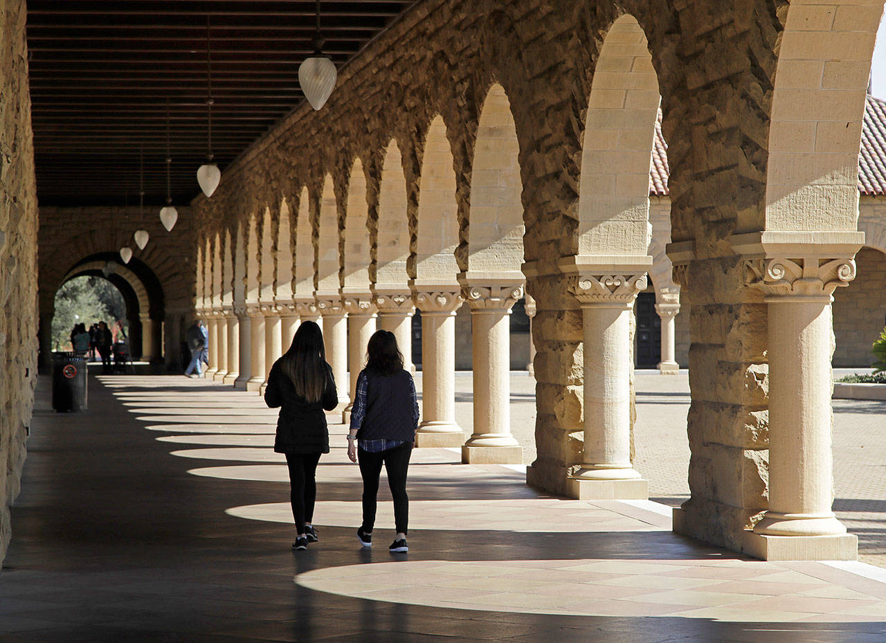 Students walk on the Stanford University campus in Santa Clara, California. Before student loans, people who couldn’t afford to go to college usually didn’t. (Ben Margot / AP file)