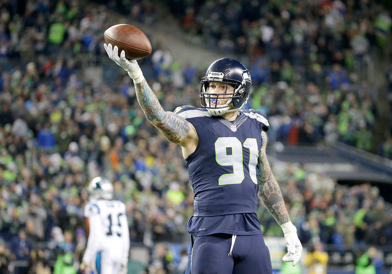 Seattle Seahawks’ Cassius Marsh reacts to a fumble recovery against the Carolina Panthers during a game on Dec. 4, 2016, in Seattle. (Ted S. Warren / Associated Press)