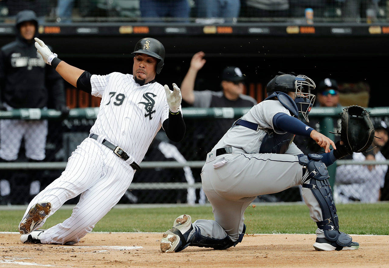 The White Sox’s Jose Abreu scores on a two-run double by Yoan Moncada as Mariners catcher Omar Narvaez waits for the ball during the first inning of a game on April 5, 2019, in Chicago. (AP Photo/Nam Y. Huh)